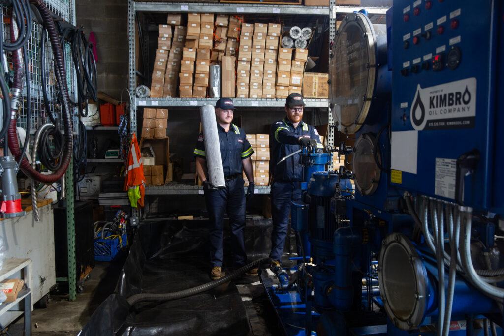Two Kimbro technicians working beside an industrial filtration unit