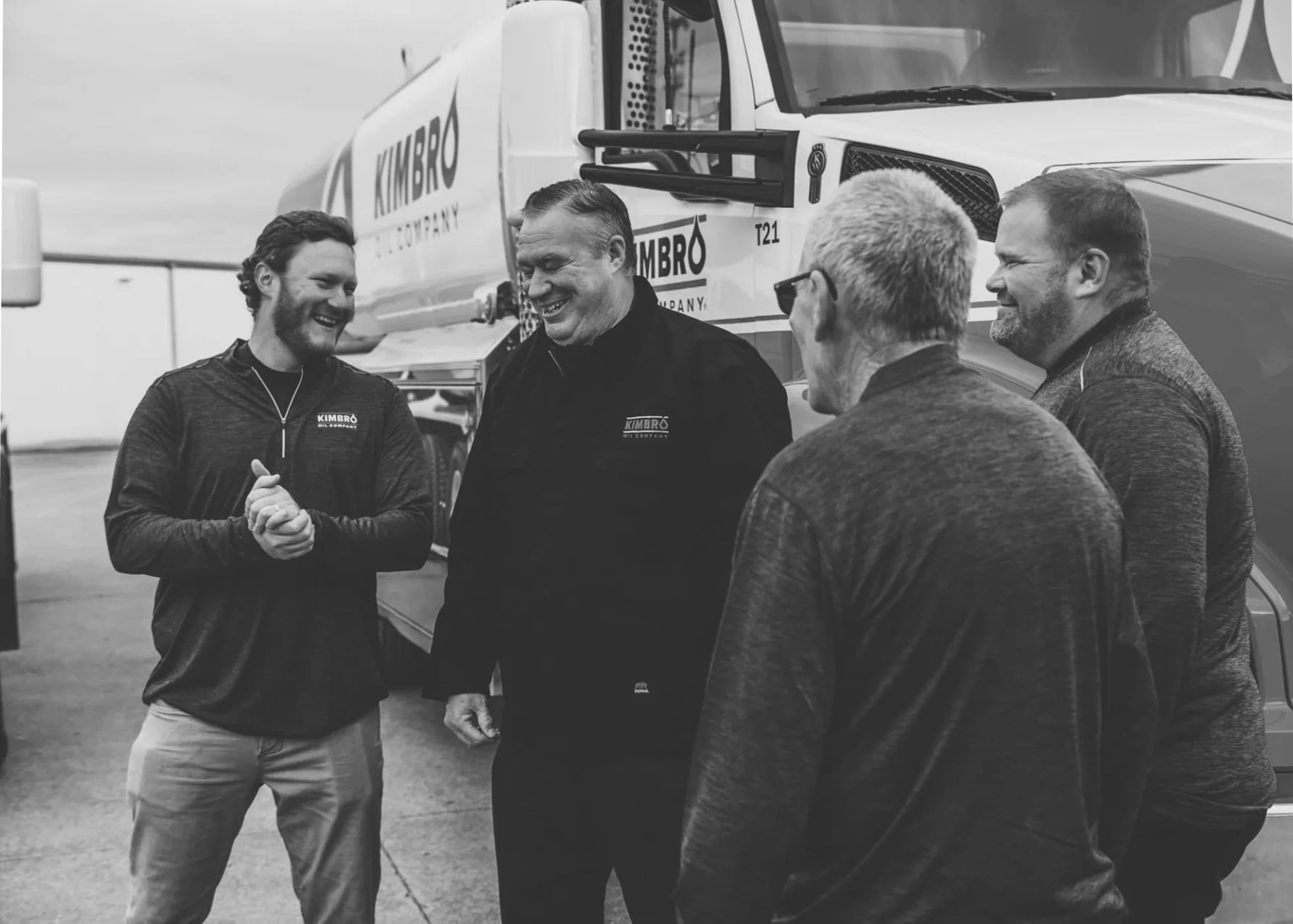Kimbro team members talking in front of a Kimbro delivery truck