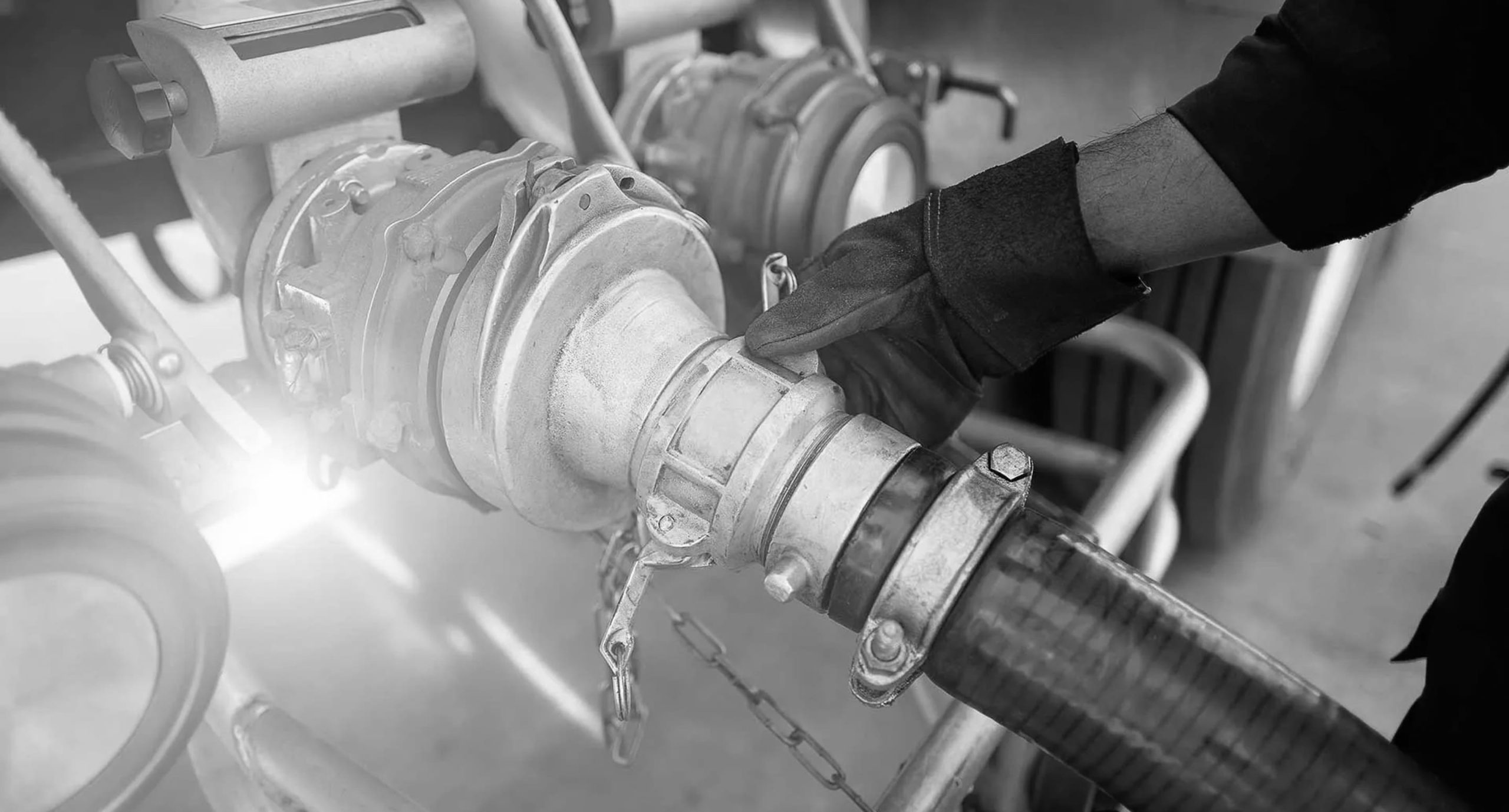Technician connecting a hose coupling for a bulk fluid transfer