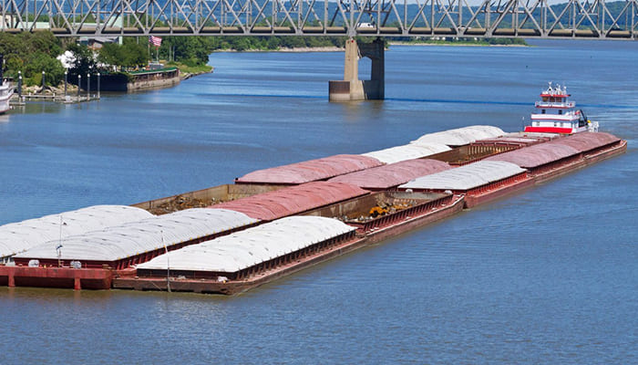 Towboat pushing barges along a river