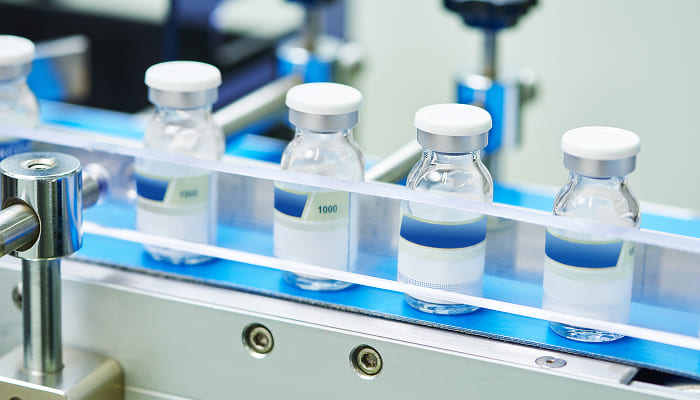 Pharmaceutical vials moving along a production line