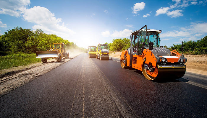 Road roller paving a new asphalt road