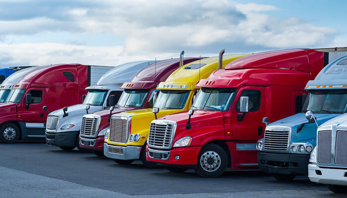 Row of semi-trucks parked side by side