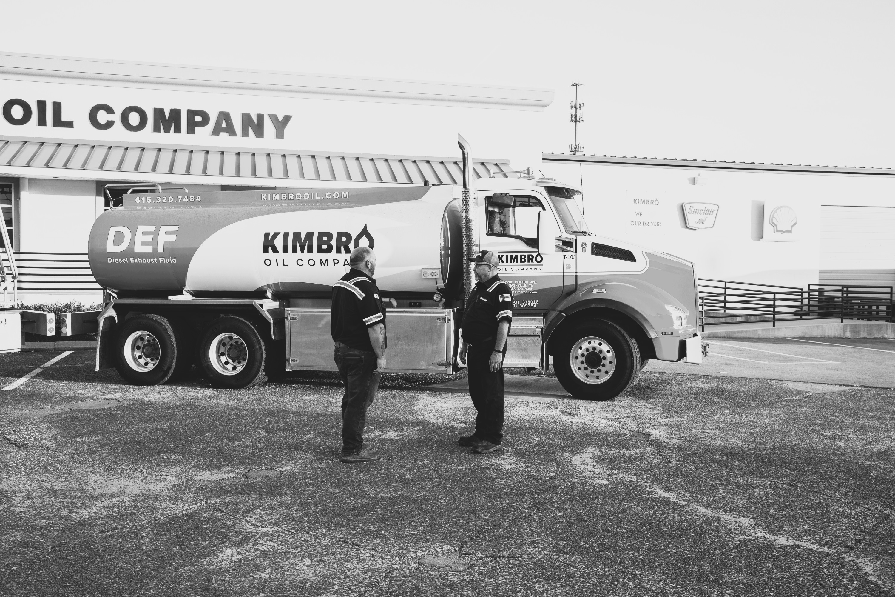 Kimbro DEF delivery truck with two employees