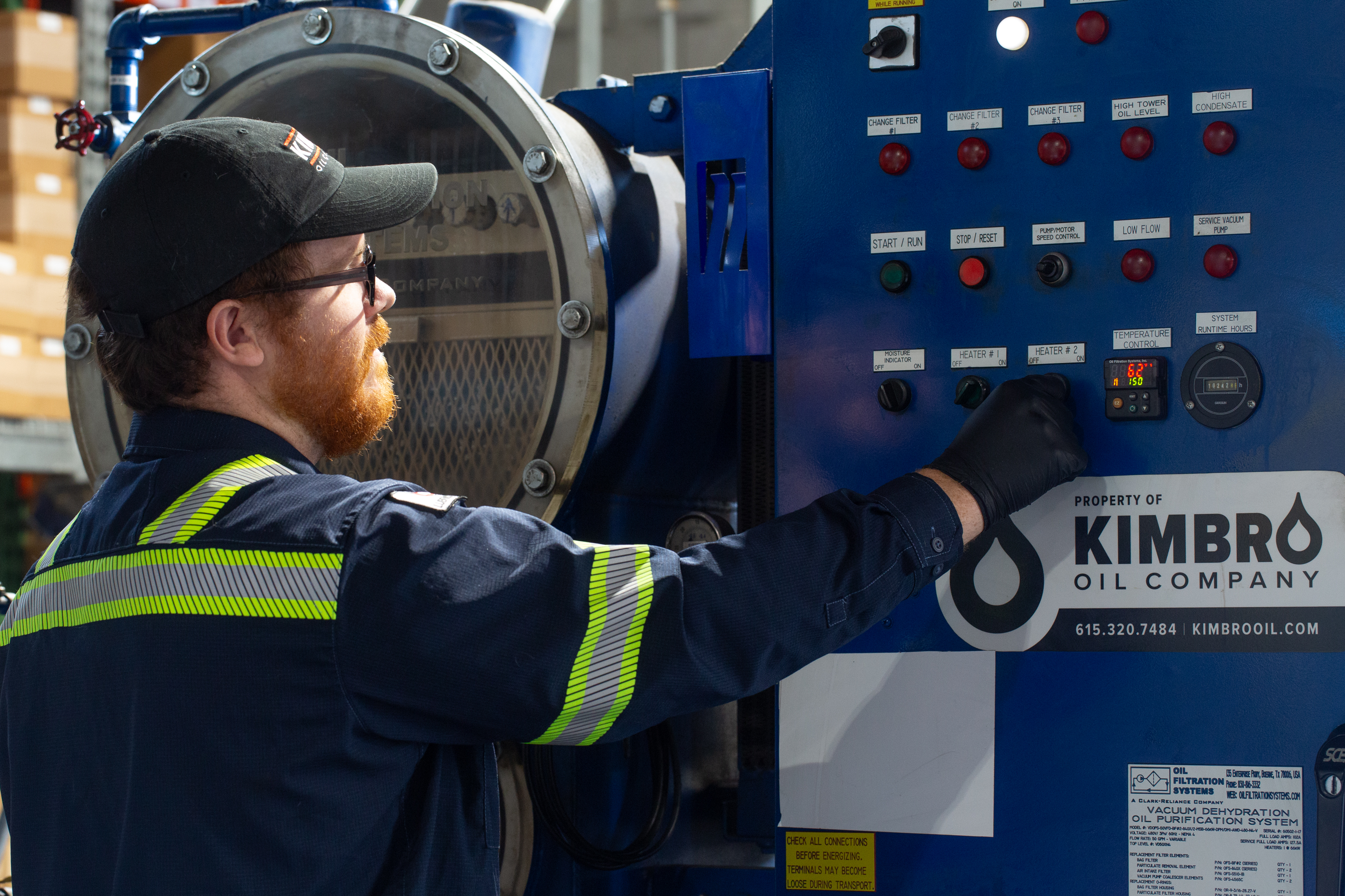 Kimbro technician at the control panel of an industrial filtration unit