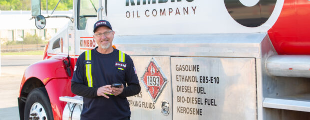 Kimbro driver standing beside a Kimbro fuel delivery truck