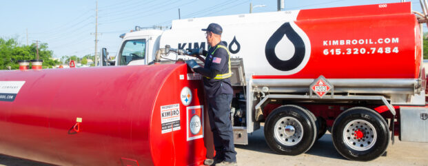 Kimbro driver checking a red bulk fuel tank