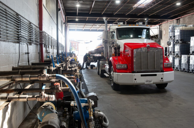 Red semi-truck in the Kimbro warehouse beside lubricant dispensing equipment
