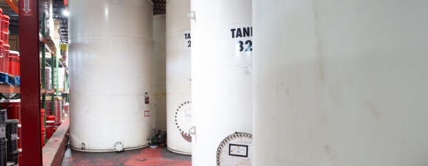White bulk lubricant storage tanks in the Kimbro warehouse