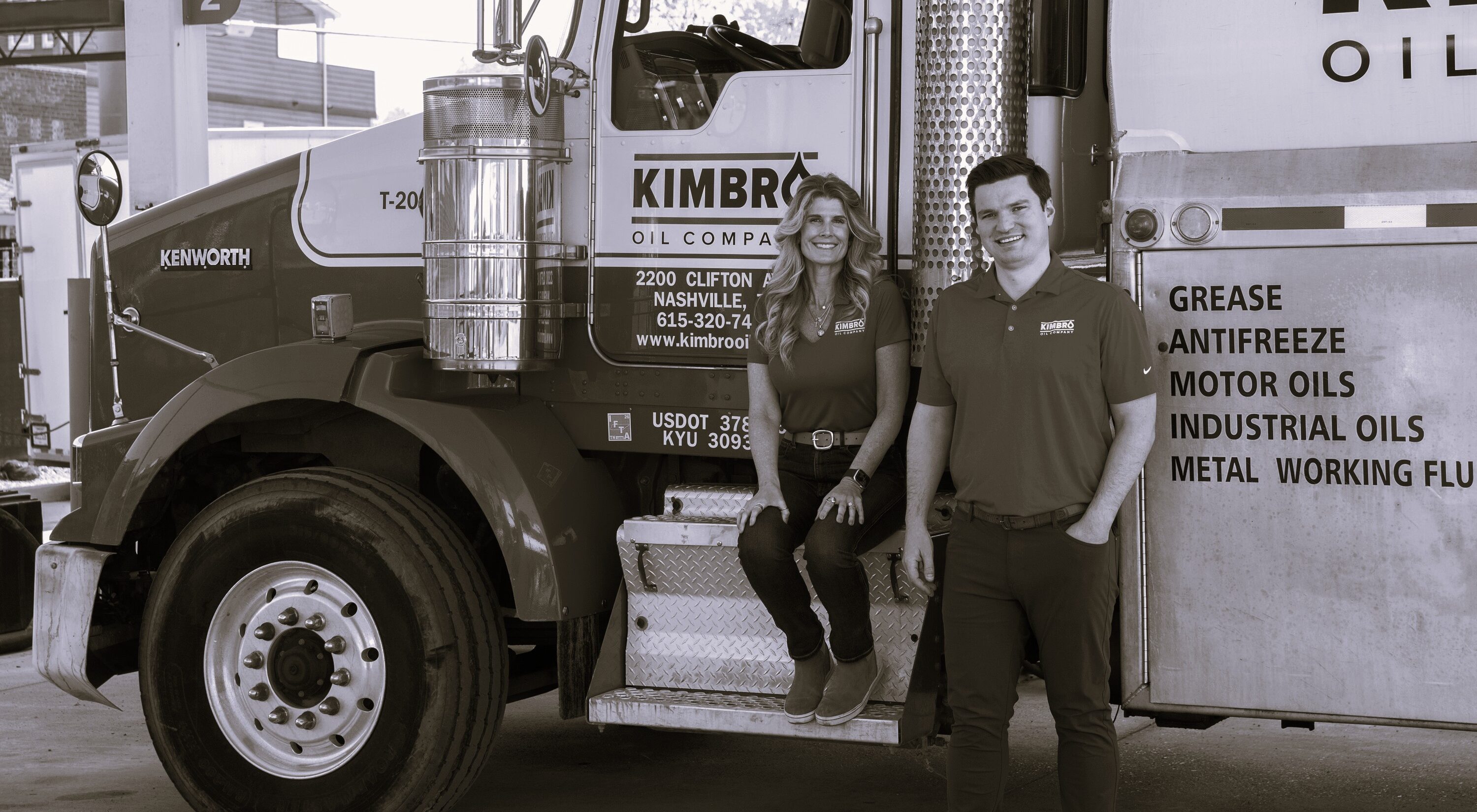 Two Kimbro employees on the step of a Kimbro lubricant delivery truck